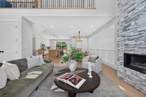 88 Woodlark Drive Sw, Calgary, AB - Indoor Photo Showing Living Room With Fireplace