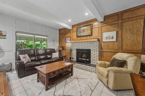 75 Deerbrook Road Se, Calgary, AB - Indoor Photo Showing Living Room With Fireplace
