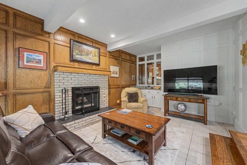75 Deerbrook Road Se, Calgary, AB - Indoor Photo Showing Living Room With Fireplace