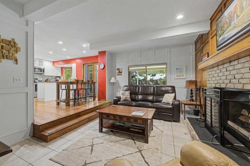 75 Deerbrook Road Se, Calgary, AB - Indoor Photo Showing Living Room With Fireplace