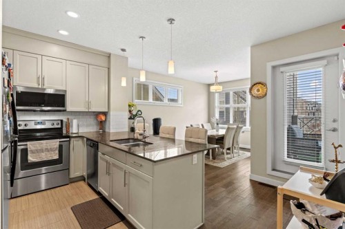 130 Silverado Plains Park Sw, Calgary, AB - Indoor Photo Showing Kitchen With Stainless Steel Kitchen With Double Sink With Upgraded Kitchen