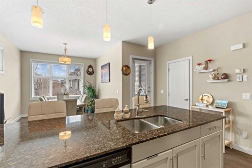 130 Silverado Plains Park Sw, Calgary, AB - Indoor Photo Showing Kitchen With Fireplace With Double Sink