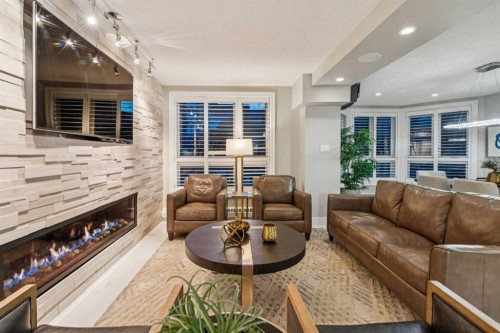 8203-400 Eau Claire Avenue Sw, Calgary, AB - Indoor Photo Showing Living Room With Fireplace