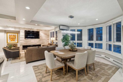 8203-400 Eau Claire Avenue Sw, Calgary, AB - Indoor Photo Showing Dining Room With Fireplace