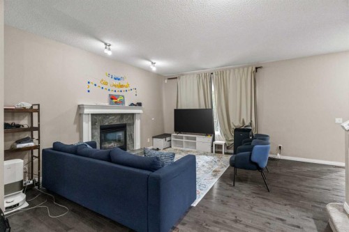 10 Nolanfield Heights Nw, Calgary, AB - Indoor Photo Showing Living Room With Fireplace