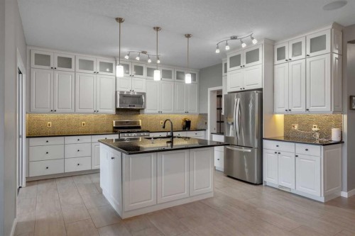 353 Kinniburgh Boulevard, Chestermere, AB - Indoor Photo Showing Kitchen With Stainless Steel Kitchen With Upgraded Kitchen