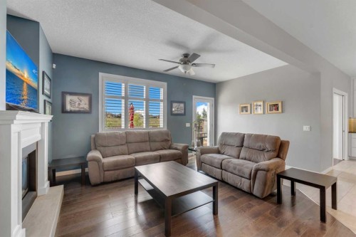 353 Kinniburgh Boulevard, Chestermere, AB - Indoor Photo Showing Living Room With Fireplace