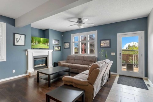 353 Kinniburgh Boulevard, Chestermere, AB - Indoor Photo Showing Living Room With Fireplace