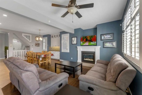 353 Kinniburgh Boulevard, Chestermere, AB - Indoor Photo Showing Living Room With Fireplace